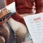 finance-debt-and-payment-with-documents-in-a-hand