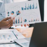 Financial businessman calculating corporate income tax data And analyzing charts of financial stocks