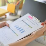 Close - up shot of Executives are checking the company's revenue graphs.