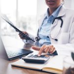 Accounting doctor, calculator and hands of person calculating bookkeeping finance, hospital budget