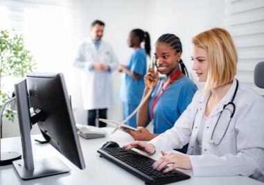 Diverse medical team working in busy modern hospital office