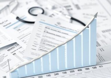 Medical billing documents with upward revenue chart