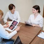 Doctors discussing medical scans during meeting