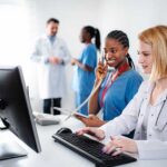 Diverse medical team working in busy modern hospital office