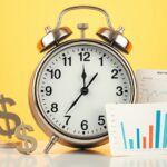 Alarm clock beside dollar signs and billing charts