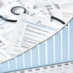 Medical billing documents with upward revenue chart